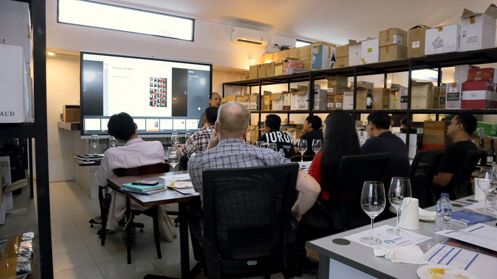 Students reviewing wine labels and origin details during class